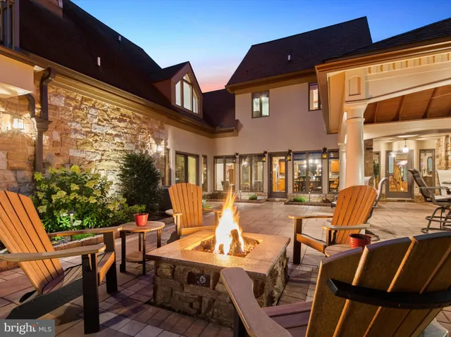 a living room with fireplace furniture and a wooden floor