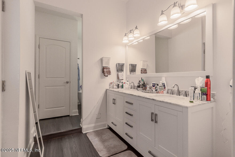 14443 Stacey Road Jacksonville, FL 32250 - Photo 16 of 31 a bathroom with a sink vanity granite and a mirror