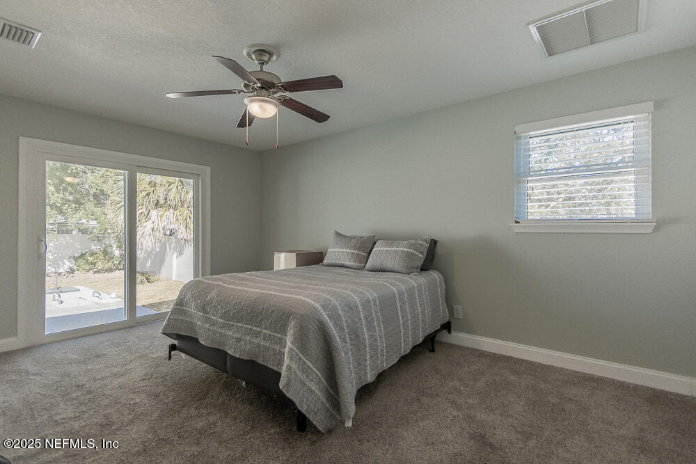 14443 Stacey Road Jacksonville, FL 32250 - Photo 18 of 31 a spacious bedroom with a bed and window