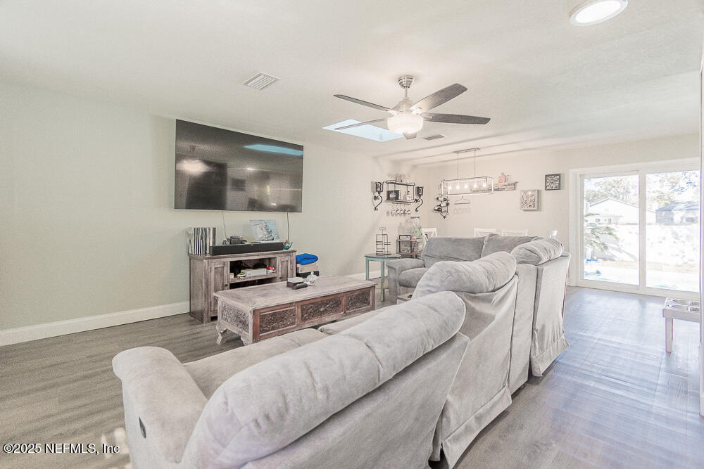 14443 Stacey Road Jacksonville, FL 32250 - Photo 3 of 31 a living room with furniture a flat screen tv and a large window