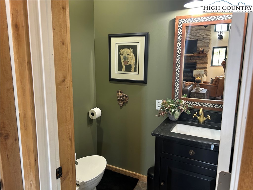 509 Grant Houck Road Todd, NC 28684 - Photo 24 of 50 a bathroom with a toilet sink and mirror