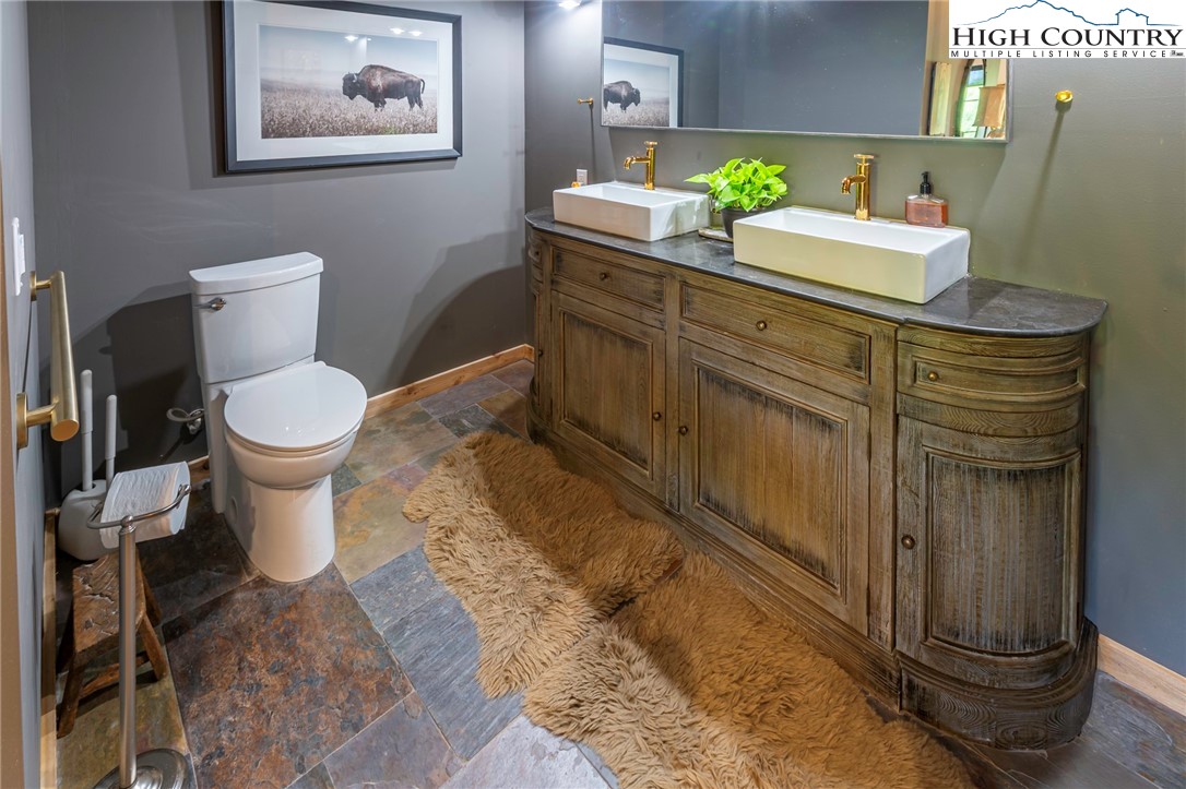 509 Grant Houck Road Todd, NC 28684 - Photo 37 of 50 a bathroom with a toilet sink and mirror
