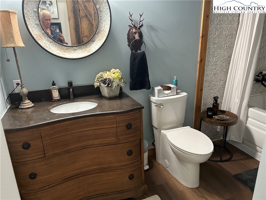 509 Grant Houck Road Todd, NC 28684 - Photo 38 of 50 a bathroom with a toilet a sink and a mirror