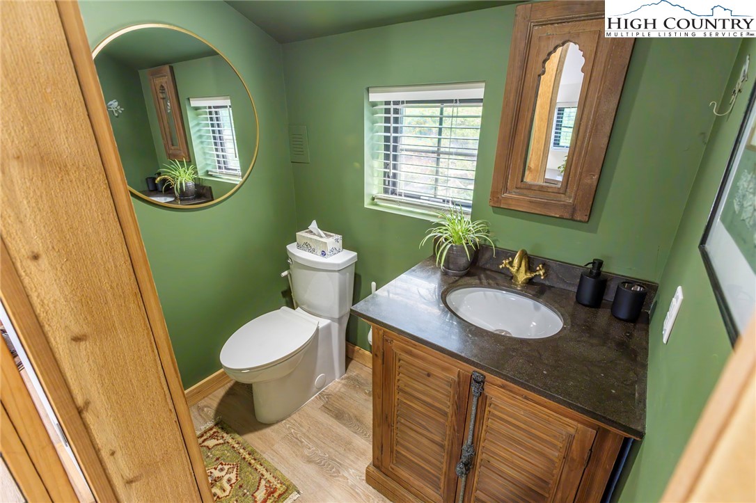 509 Grant Houck Road Todd, NC 28684 - Photo 46 of 50 a bathroom with a toilet sink and mirror