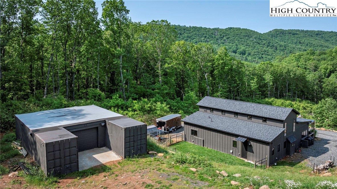 509 Grant Houck Road Todd, NC 28684 - Photo 5 of 50 an aerial view of a house with swimming pool and trees in the background