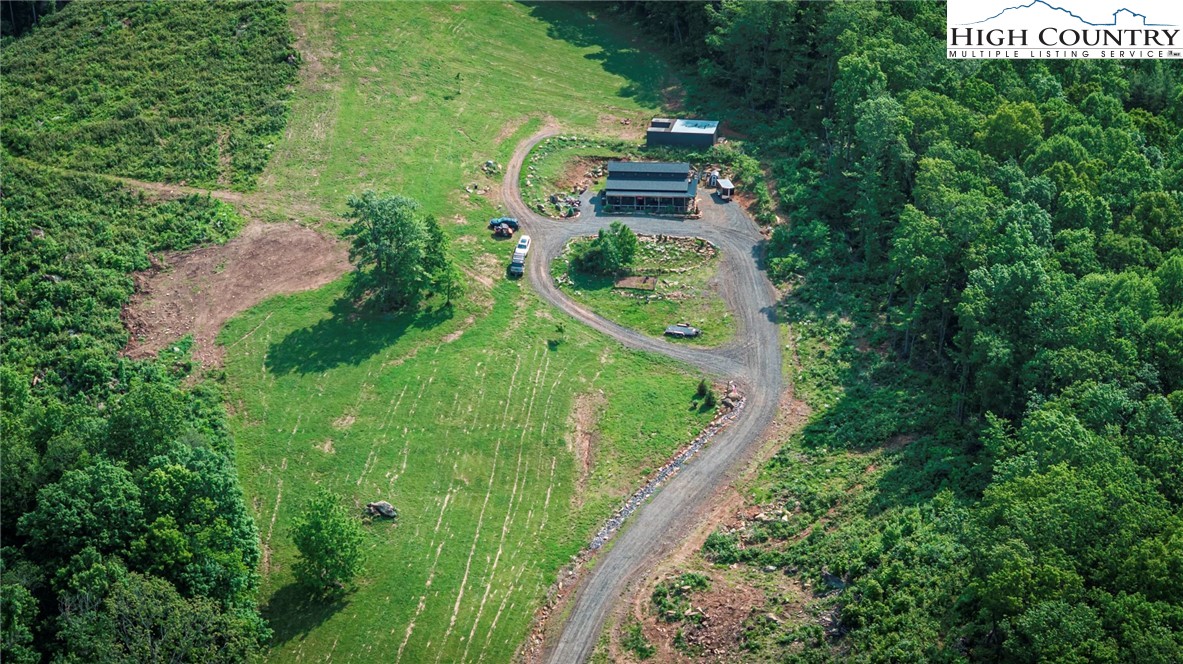 509 Grant Houck Road Todd, NC 28684 - Photo 9 of 50 an aerial view of residential house with outdoor space and trees all around