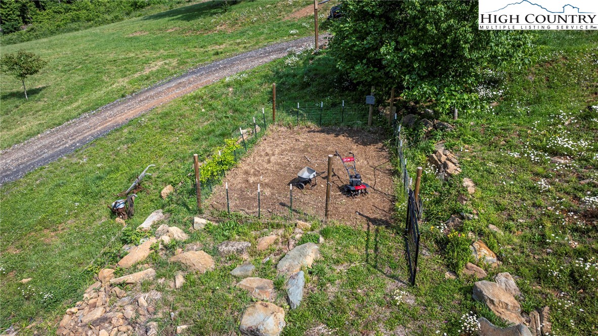 509 Grant Houck Road Todd, NC 28684 - Photo 10 of 50 a backyard of a house with lots of green space and trees