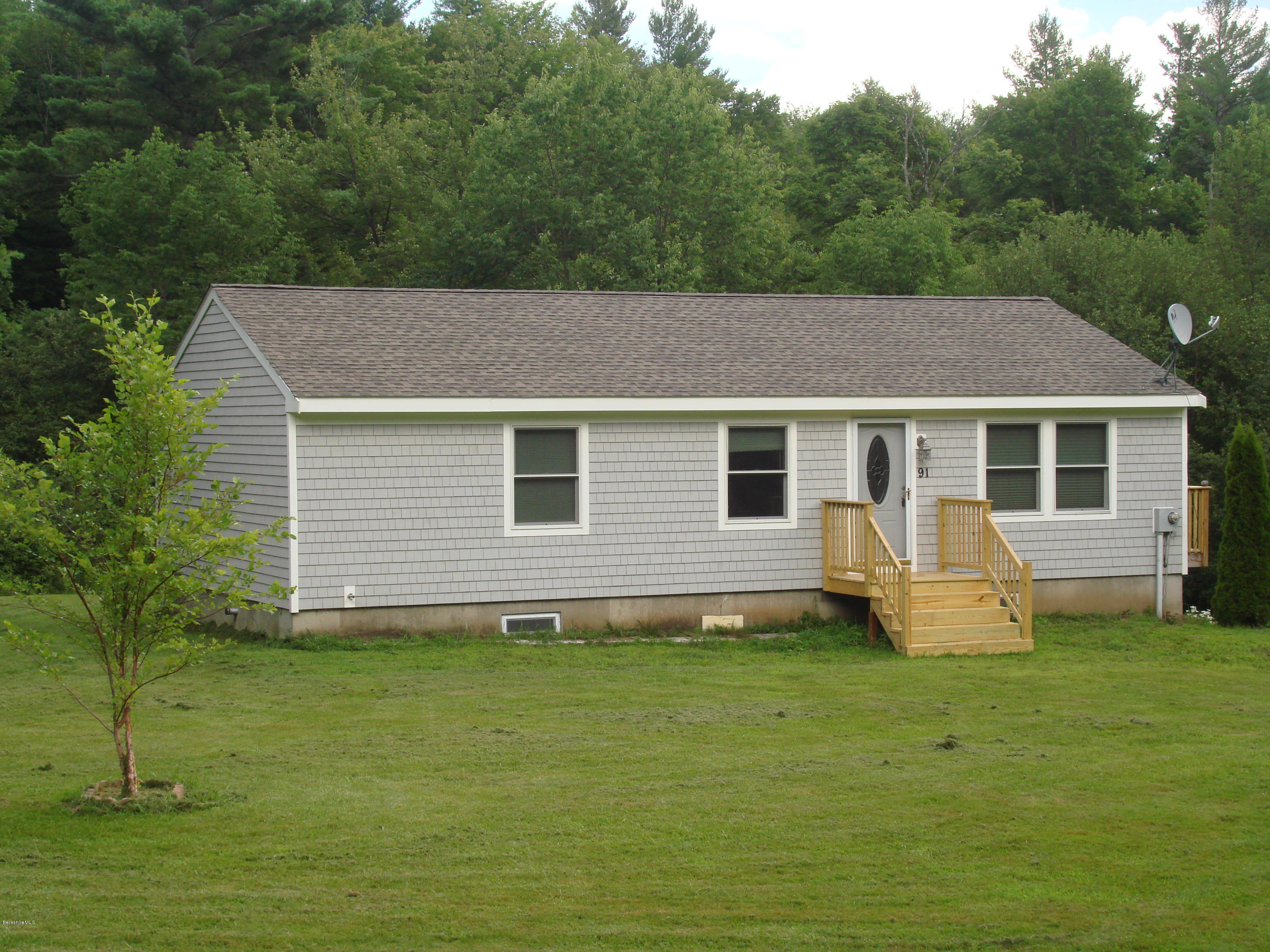 91 Middlefield Road Peru, MA 01235 - Photo 1 of 21 a house that has a big yard in front of it
