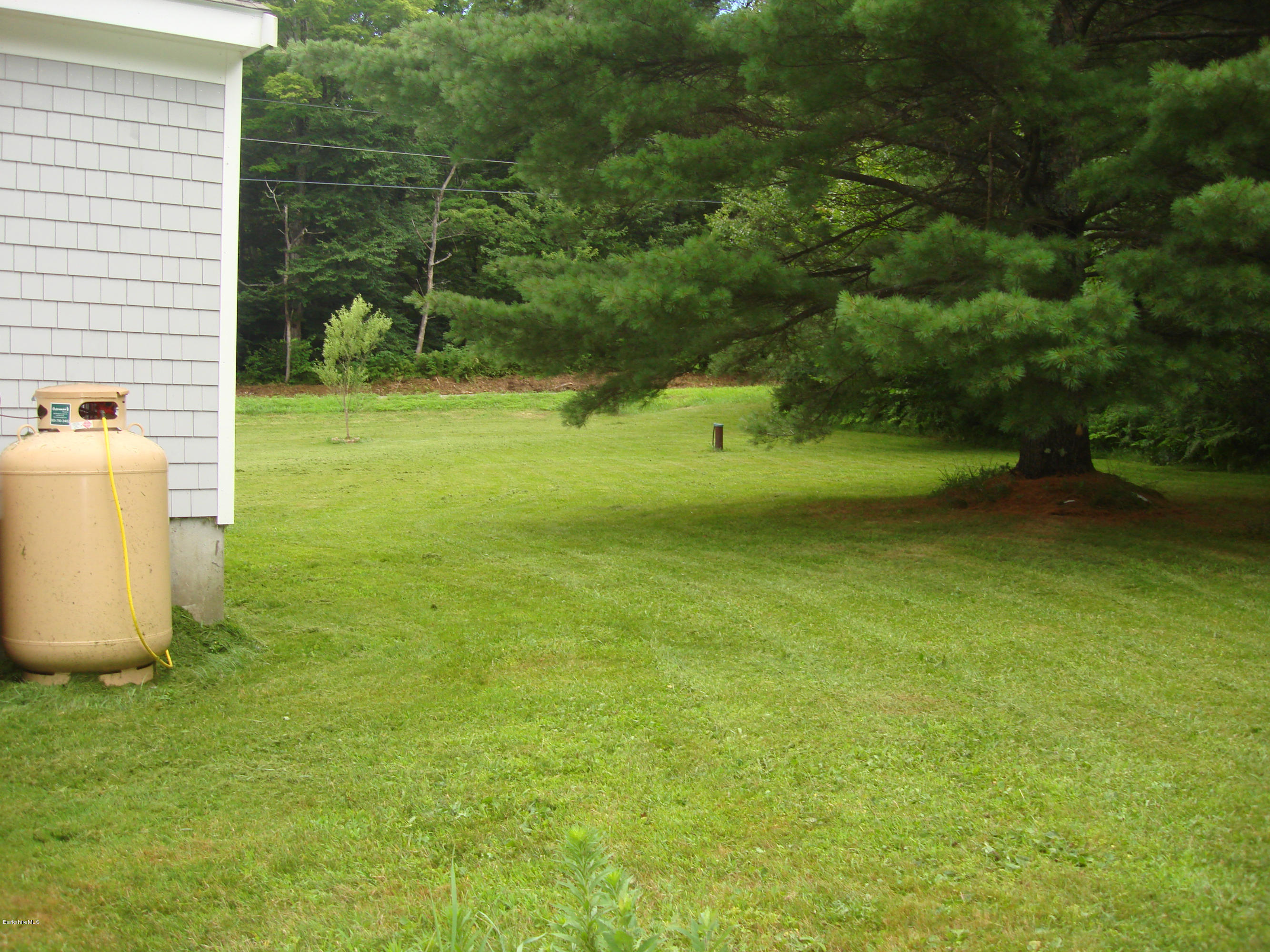 91 Middlefield Road Peru, MA 01235 - Photo 18 of 21 a view of a fountain in front of a house with a yard