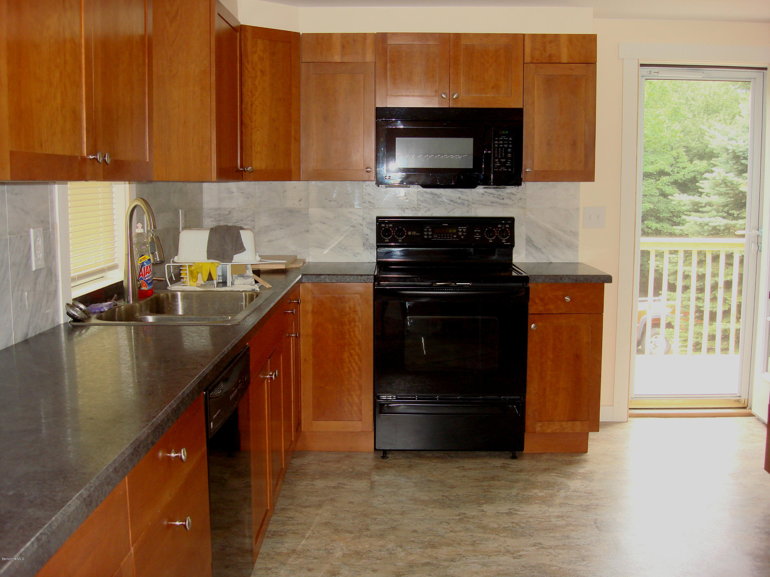 91 Middlefield Road Peru, MA 01235 - Photo 3 of 21 a kitchen with a sink and a stove top oven with wooden floor