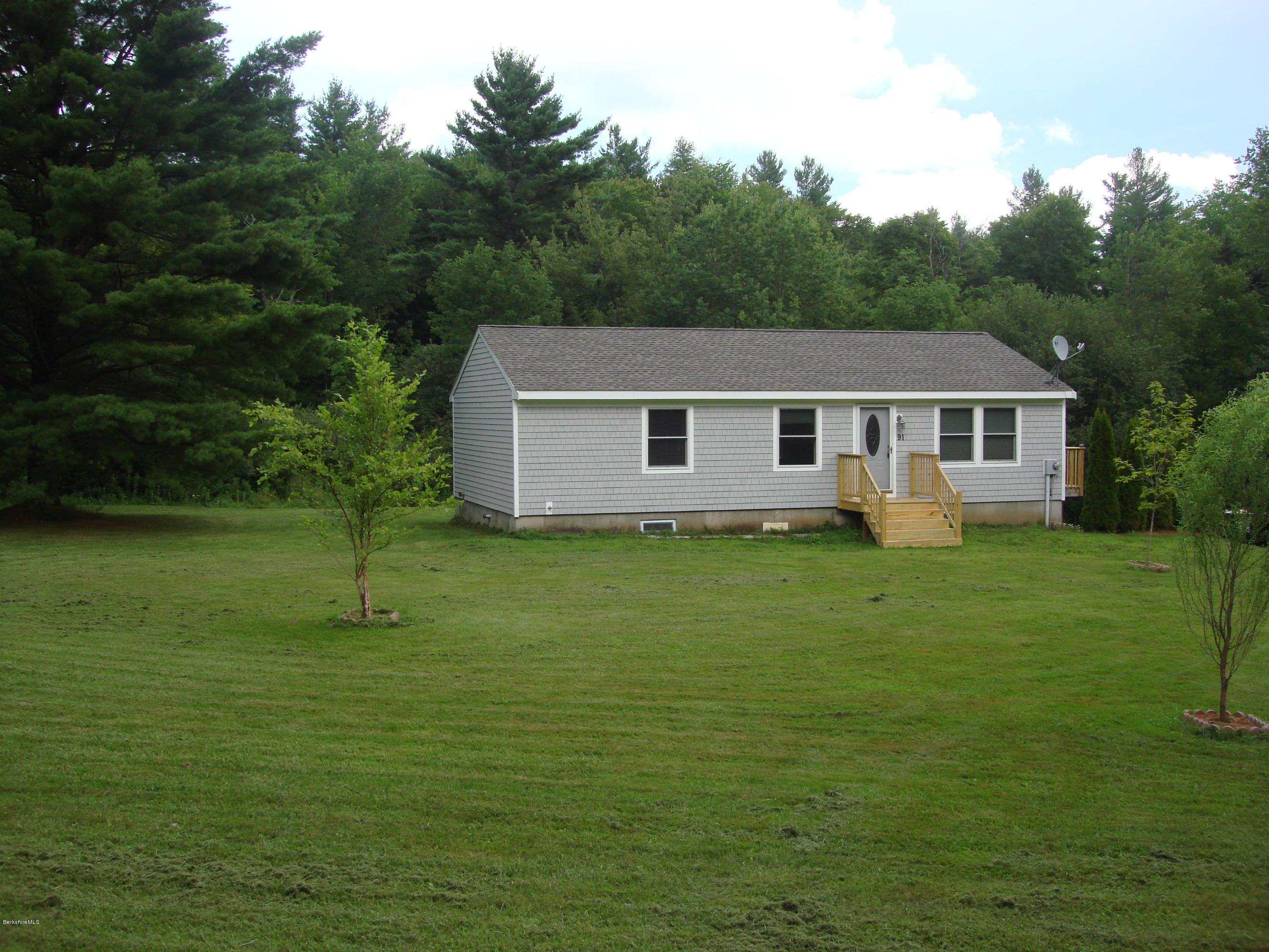91 Middlefield Road Peru, MA 01235 - Photo 21 of 21 a front view of a house with a garden
