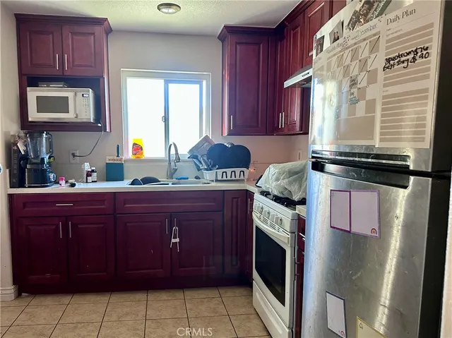 a kitchen with a sink a stove and cabinets