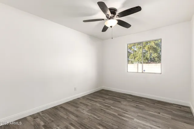 a bathroom with a granite countertop sink mirror vanity and toilet