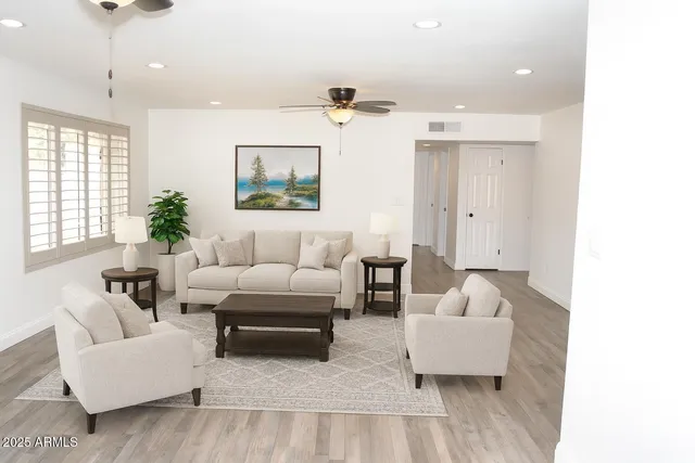 a living room with furniture and a potted plant