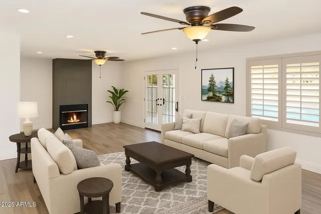 a living room with furniture ceiling fan and a window