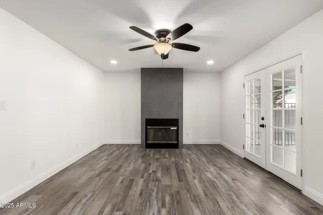 wooden floor in an empty room with a window