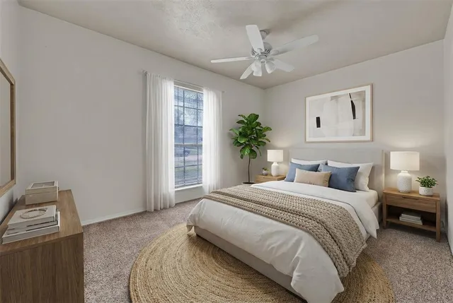 a bedroom with a large bed and a chandelier