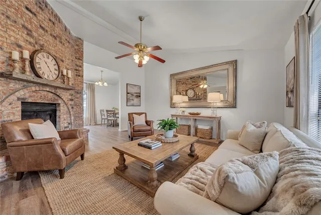 a living room with furniture a fireplace and a large window