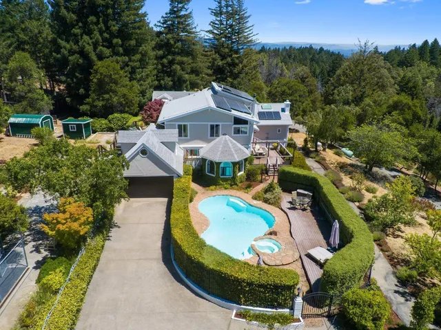an aerial view of a house with a yard