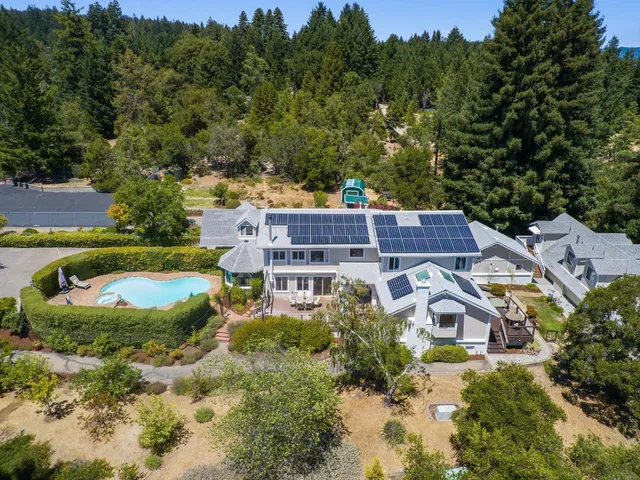 a view of a house with swimming pool and sitting area