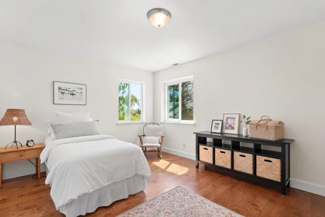 a bedroom with a bed and a lamp on table