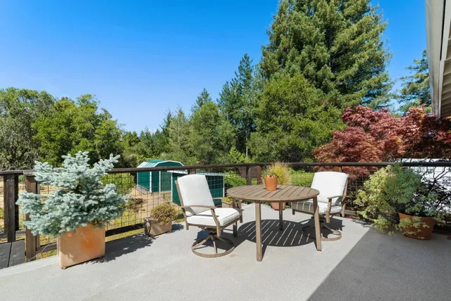 a view of a house with swimming pool and yard from a seating space