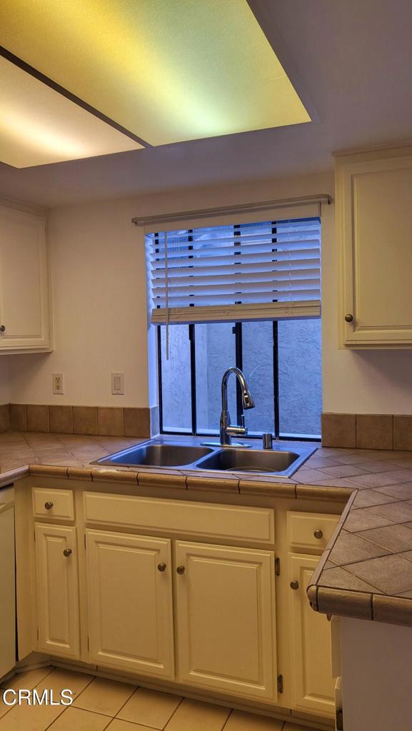 2065 East Bard Road Oxnard, CA 93033 - Photo 4 of 18 a kitchen with granite countertop white cabinets and white appliances