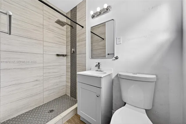 a bathroom with a toilet sink and shower