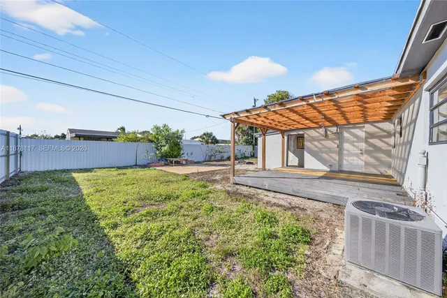a backyard of a house with table and chairs