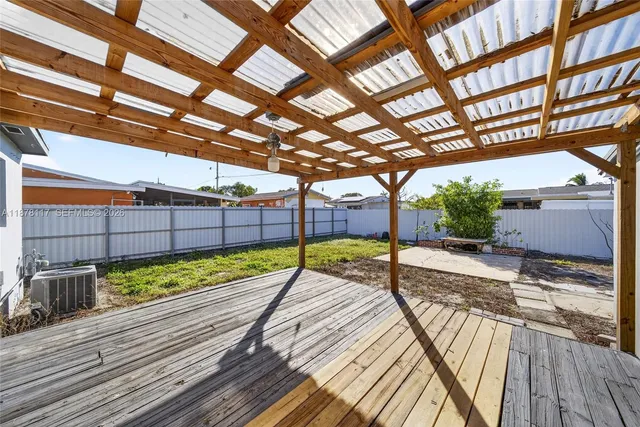 a view of a wooden deck with a yard
