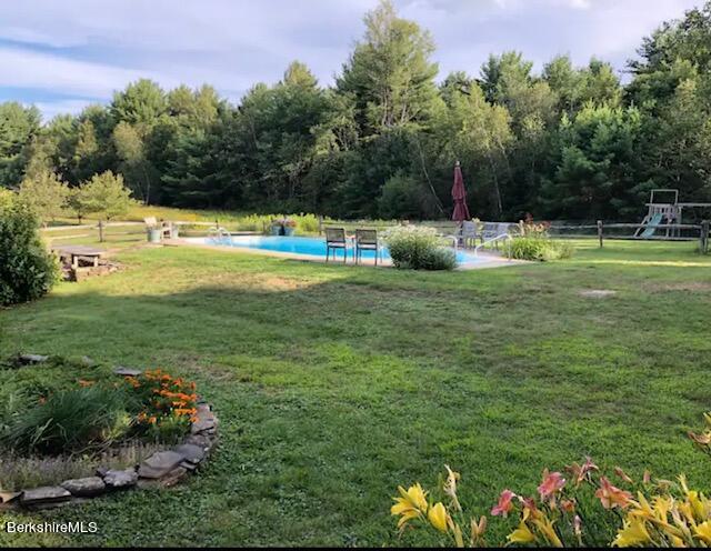 75 Old Quarry Road Otis, MA 01253 - Photo 37 of 39 a view of a house with a yard and sitting area