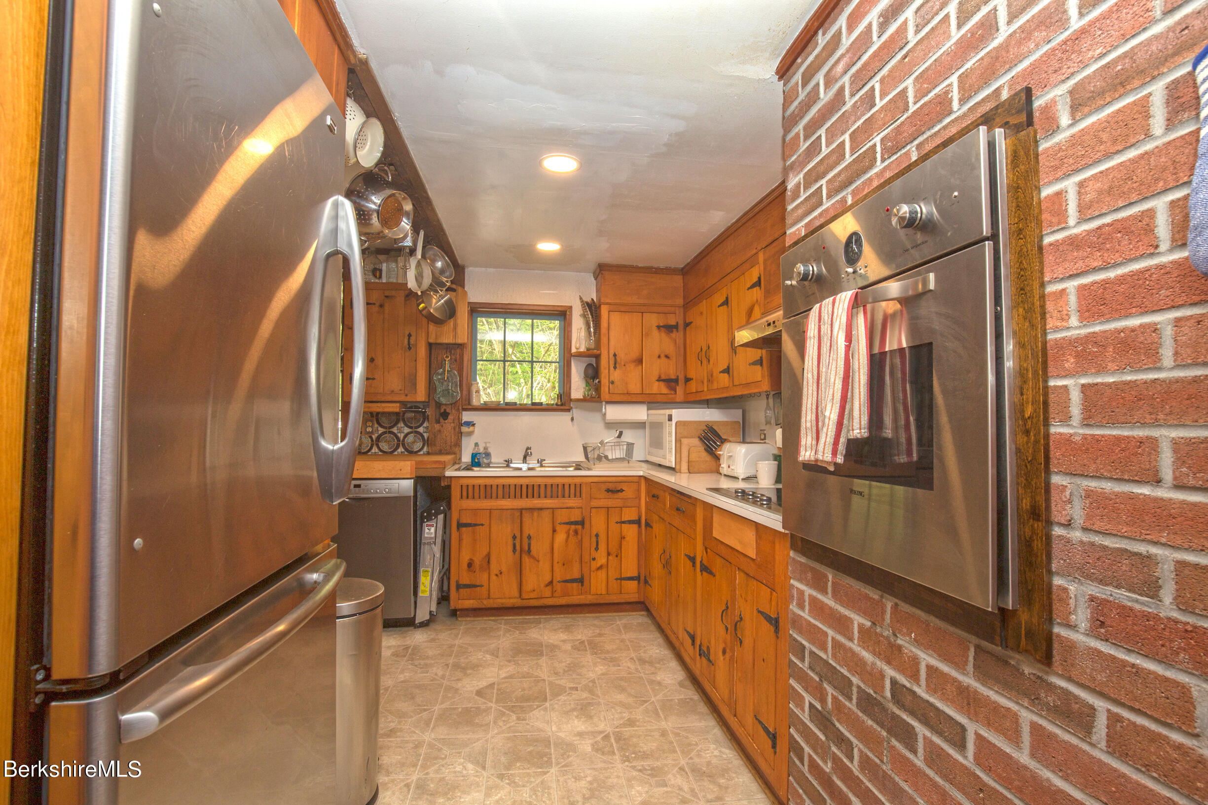 75 Old Quarry Road Otis, MA 01253 - Photo 7 of 39 a large kitchen with stainless steel appliances granite countertop a refrigerator and a stove