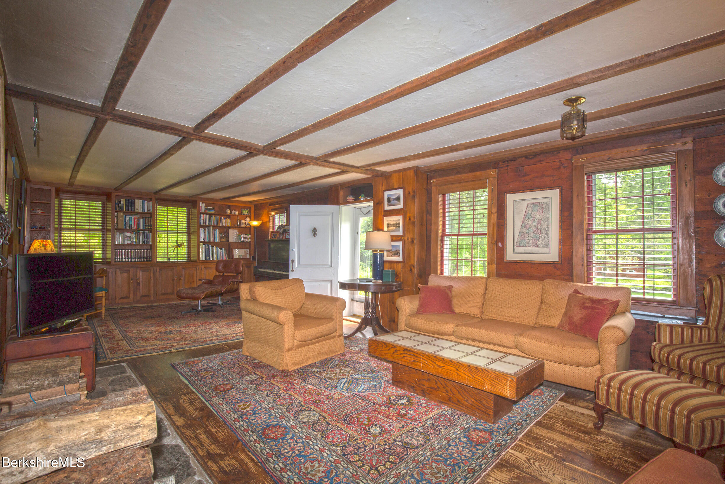 75 Old Quarry Road Otis, MA 01253 - Photo 8 of 39 a living room with furniture a flat screen tv and a large window