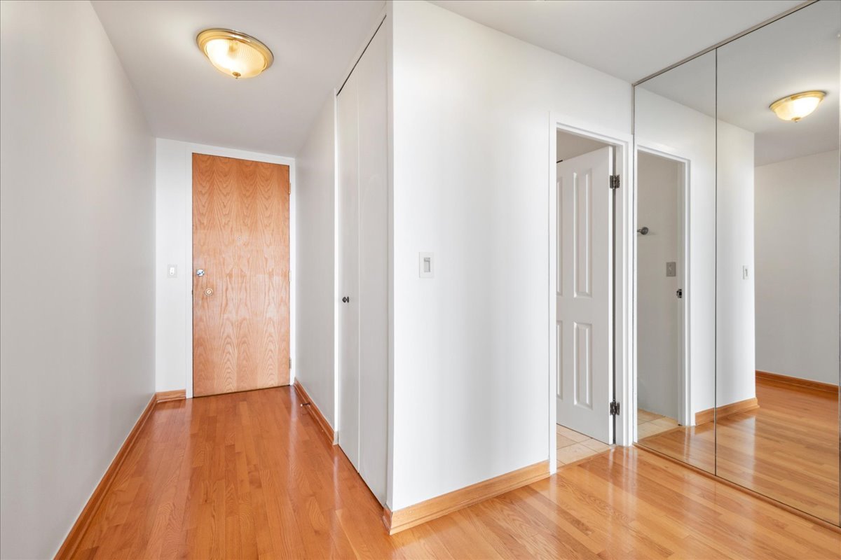 6033 North Sheridan Road, Unit 34M Chicago, IL 60660 - Photo 12 of 48 a view of a hallway with wooden floor