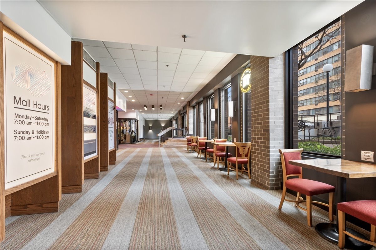 6033 North Sheridan Road, Unit 34M Chicago, IL 60660 - Photo 29 of 48 a view of a dining room with furniture window and wooden floor