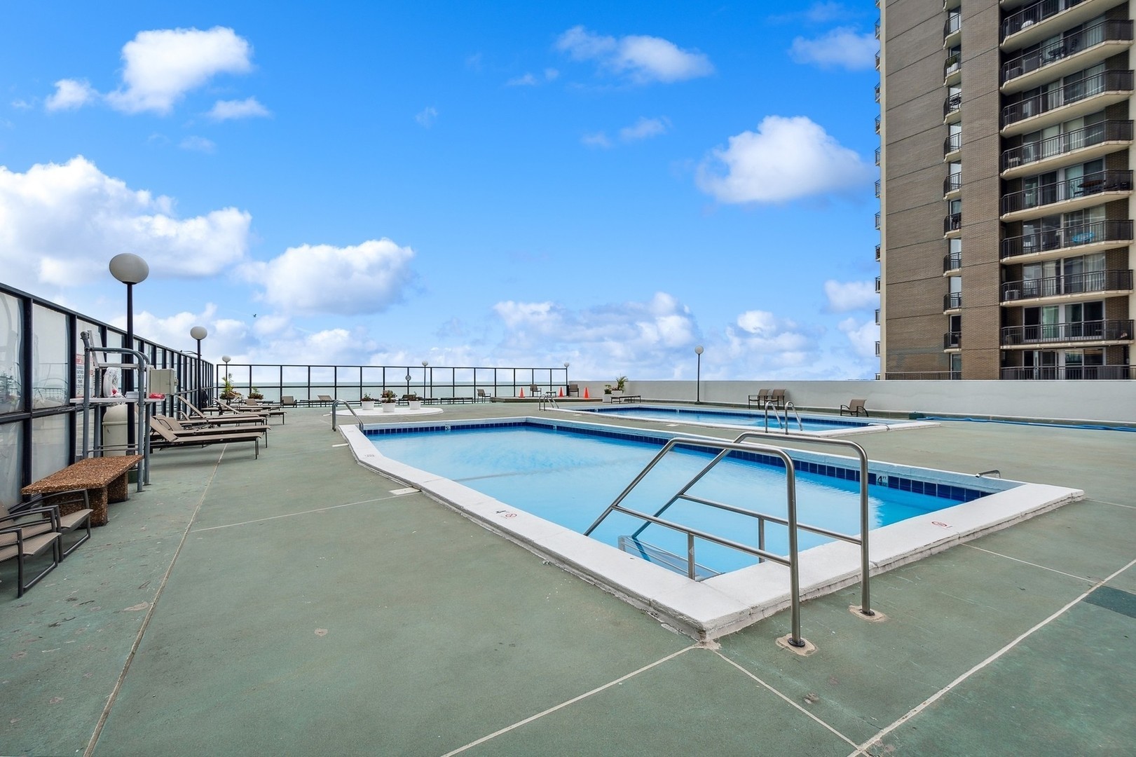 6033 North Sheridan Road, Unit 34M Chicago, IL 60660 - Photo 38 of 48 a view of a swimming pool with a lounge chairs