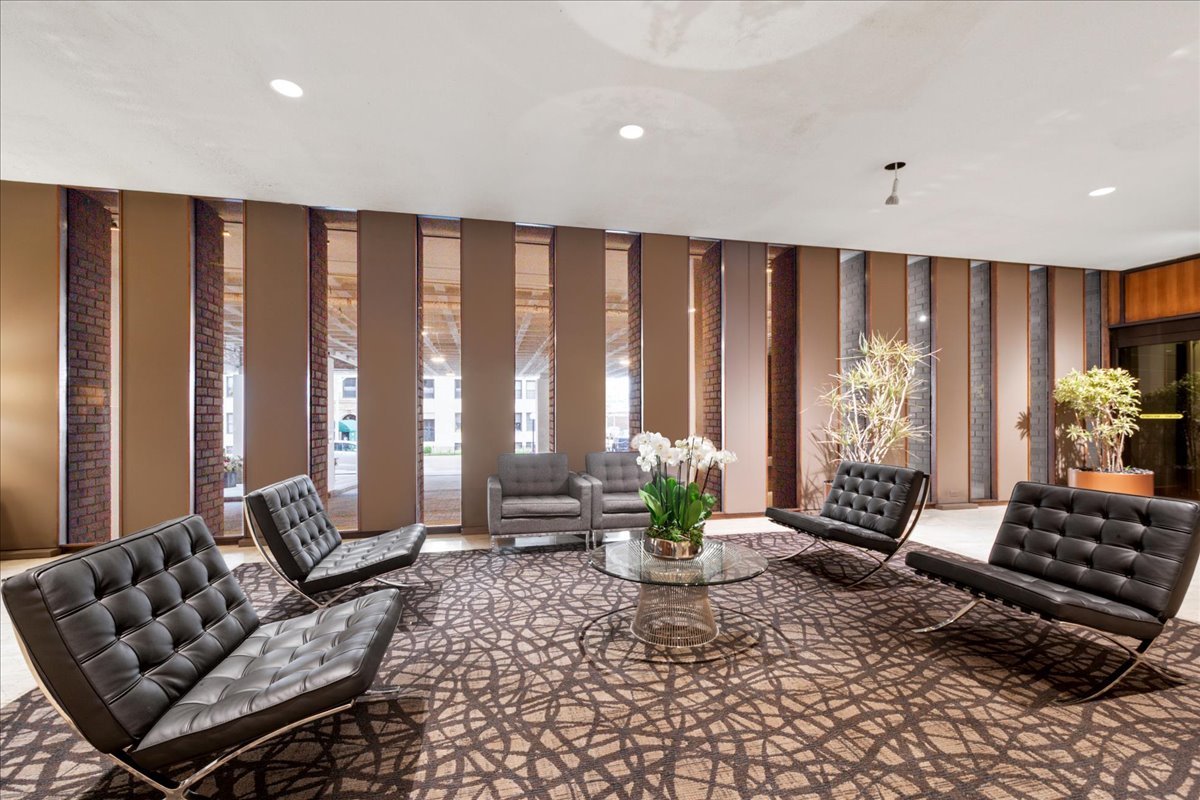 6033 North Sheridan Road, Unit 34M Chicago, IL 60660 - Photo 5 of 48 a living room with furniture and floor to ceiling windows