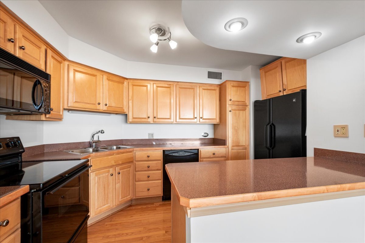 6033 North Sheridan Road, Unit 34M Chicago, IL 60660 - Photo 9 of 48 a kitchen with stainless steel appliances granite countertop a sink a stove and refrigerator