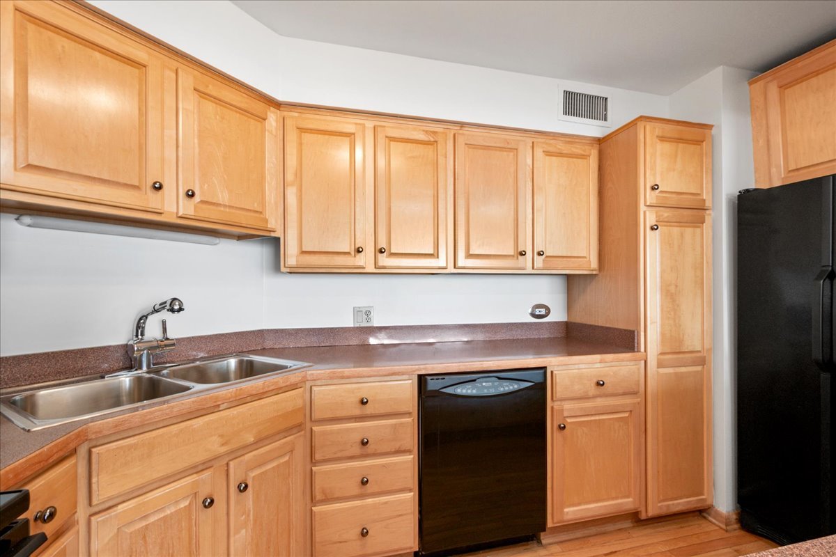 6033 North Sheridan Road, Unit 34M Chicago, IL 60660 - Photo 10 of 48 a kitchen with stainless steel appliances granite countertop a sink stove and refrigerator