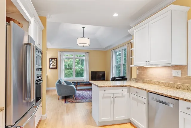 a kitchen with furniture a window and appliances