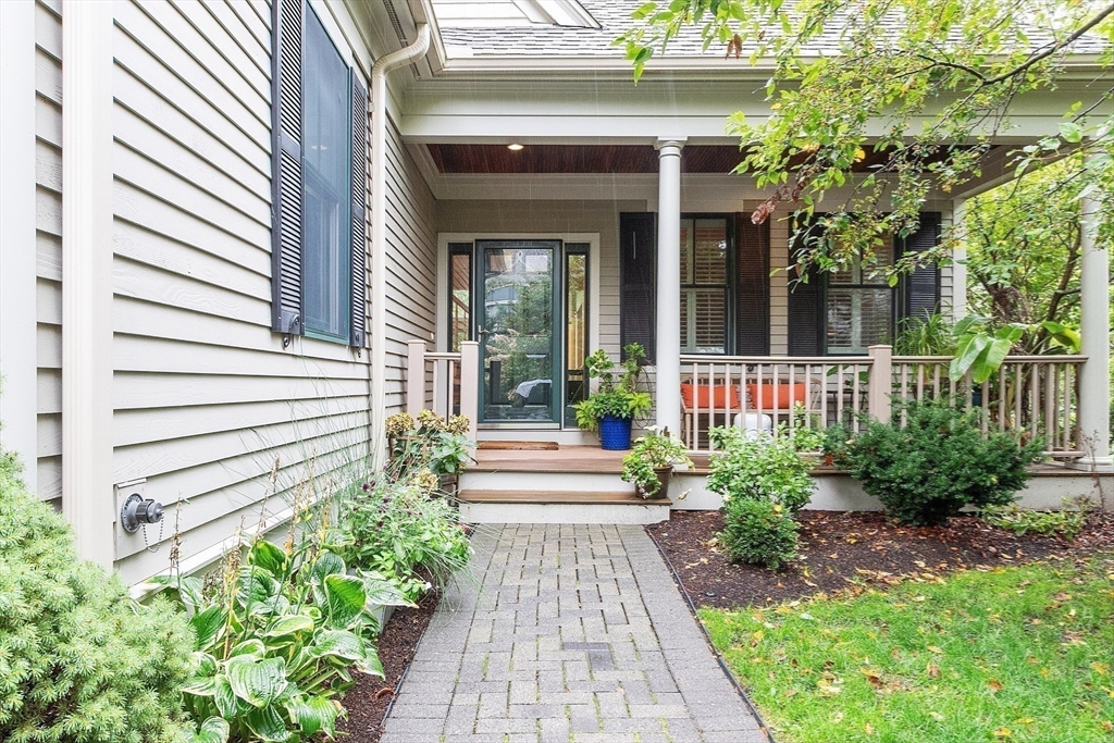 51 South Cottage Road, Unit 112 Belmont, MA 02478 - Photo 20 of 41 a front view of a house with a garden
