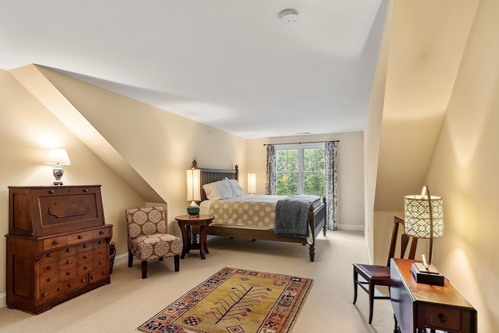 51 South Cottage Road, Unit 112 Belmont, MA 02478 - Photo 22 of 41 a bedroom with furniture and wooden floor