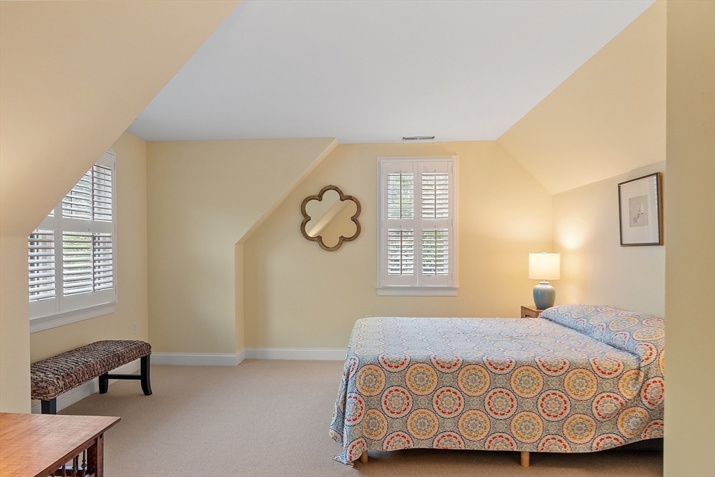 51 South Cottage Road, Unit 112 Belmont, MA 02478 - Photo 23 of 41 a bedroom with a bed and a window