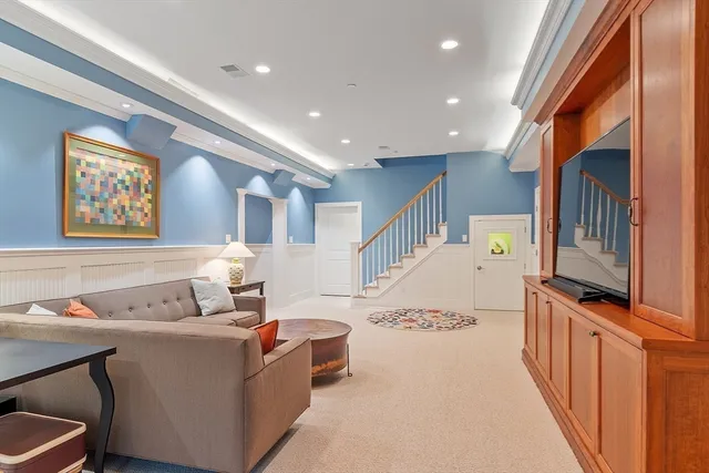 a living room with furniture a window and a flat screen tv