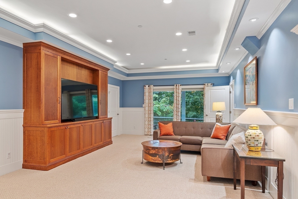51 South Cottage Road, Unit 112 Belmont, MA 02478 - Photo 26 of 41 a living room with furniture a window and a flat screen tv