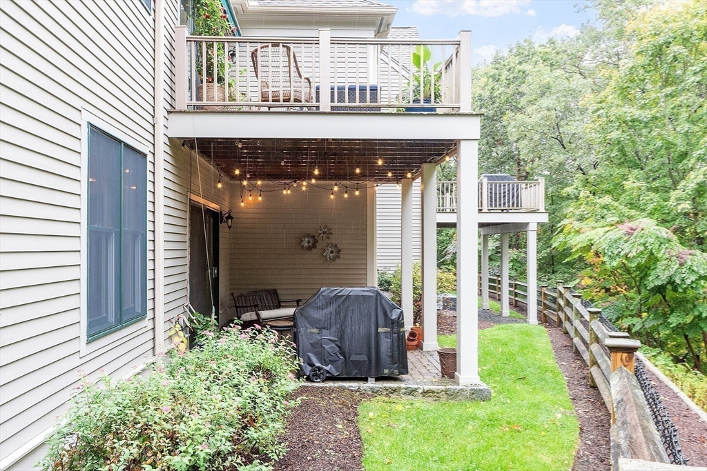 51 South Cottage Road, Unit 112 Belmont, MA 02478 - Photo 36 of 41 a view of a house with brick walls and a yard with plants