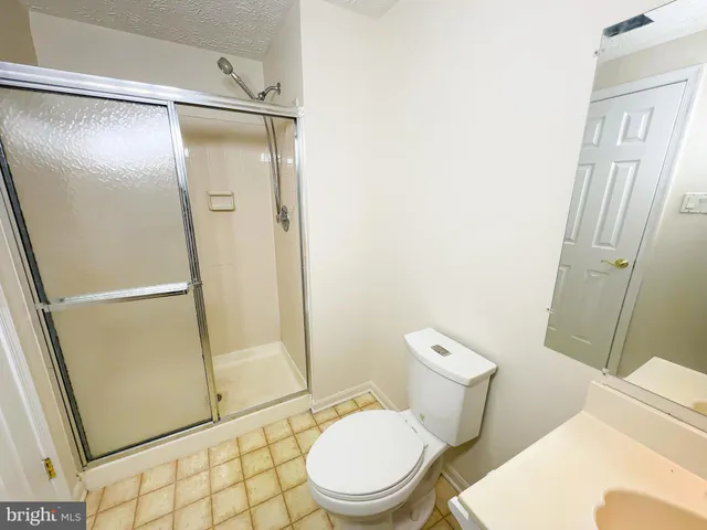 a white toilet sitting next to a bathroom sink
