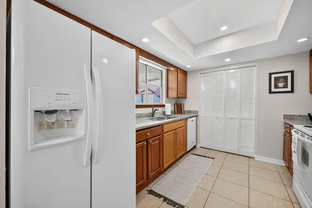 a kitchen with stainless steel appliances granite countertop a refrigerator and a sink