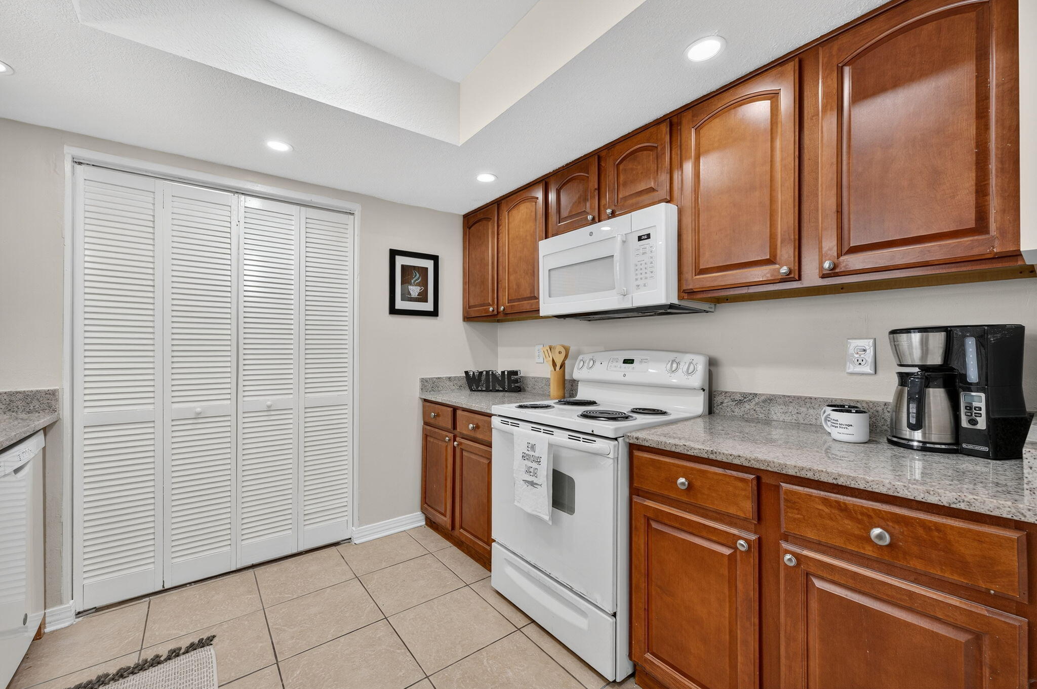 150 Beach Drive Fort Walton Beach, FL 32547 - Photo 16 of 56 a kitchen with stainless steel appliances granite countertop a sink stove and cabinets