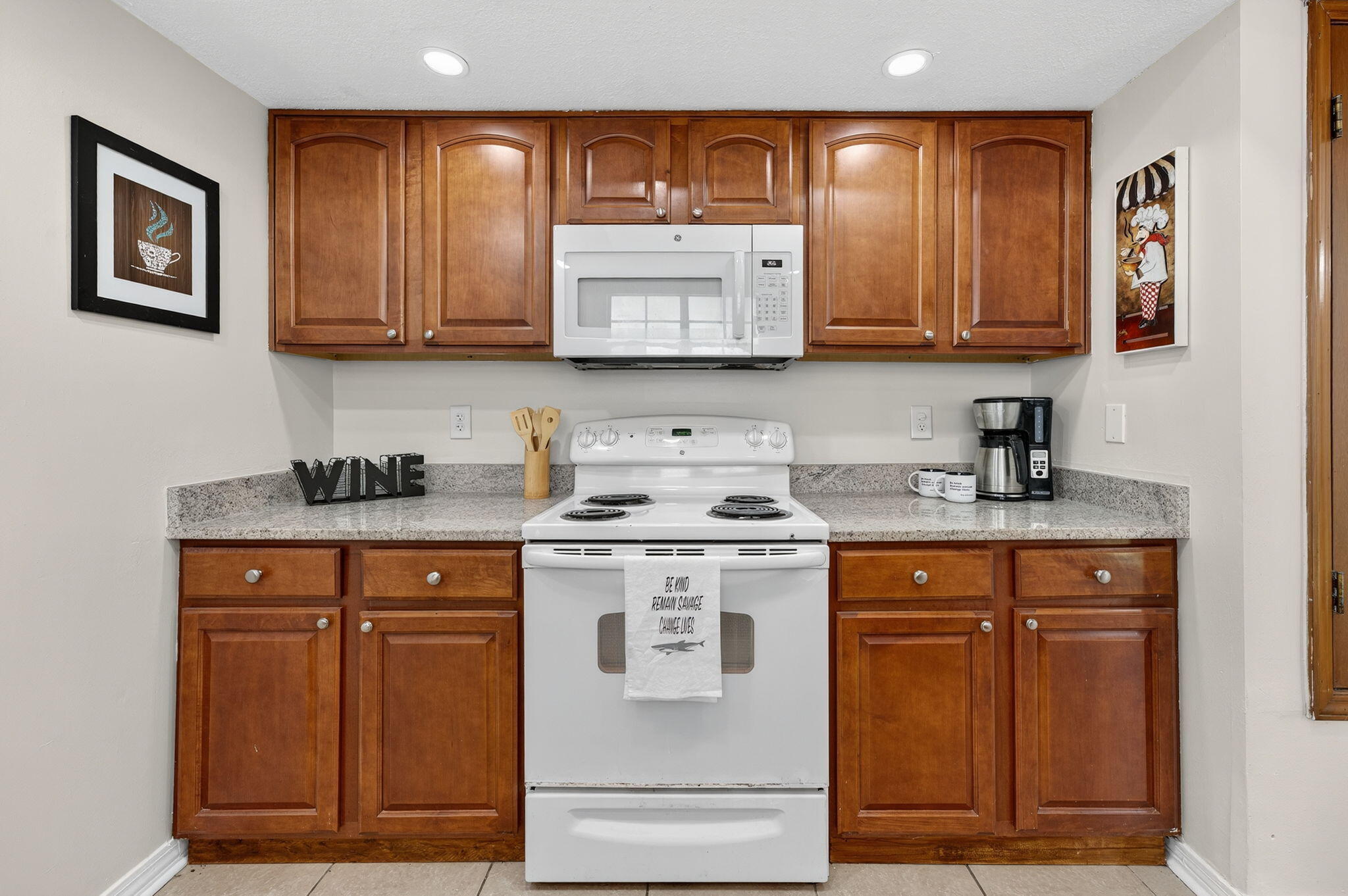 150 Beach Drive Fort Walton Beach, FL 32547 - Photo 17 of 56 a kitchen with stainless steel appliances granite countertop a stove a sink and a microwave